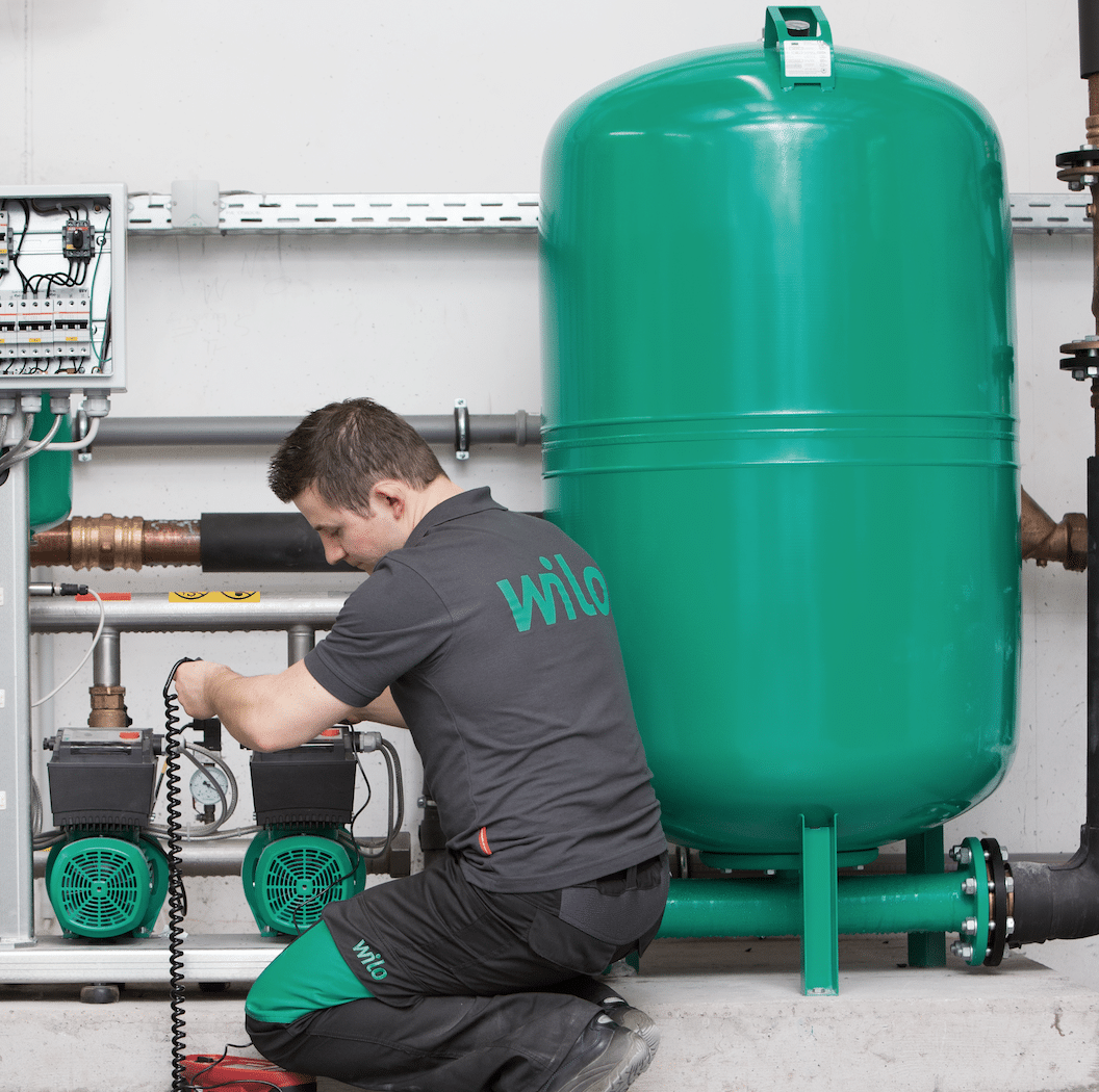 Wilo maintenance man repairing a boiler